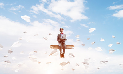 Young businessman or student in blue sky studying the science