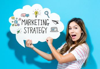 Marketing Strategy text with young woman holding a speech bubble on a blue background