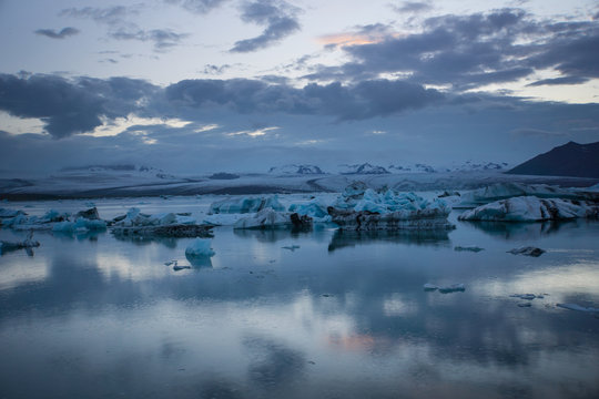 Iceland - Glowing ice floes in glacier lagoon at midnight