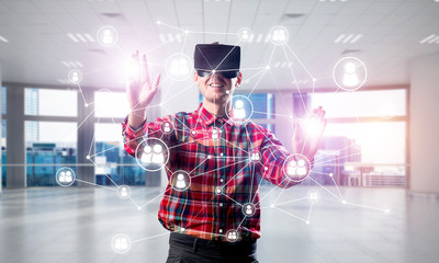 Guy wearing checked shirt and virtual mask reaching hand to touch screen