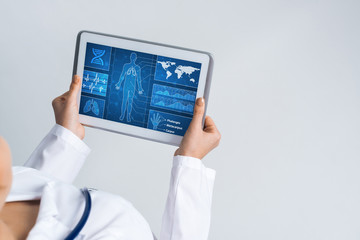 Close of female doctor hands working with tablet pc computer