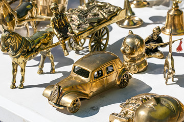 closeup of mix brass retro cars and horses for decoration