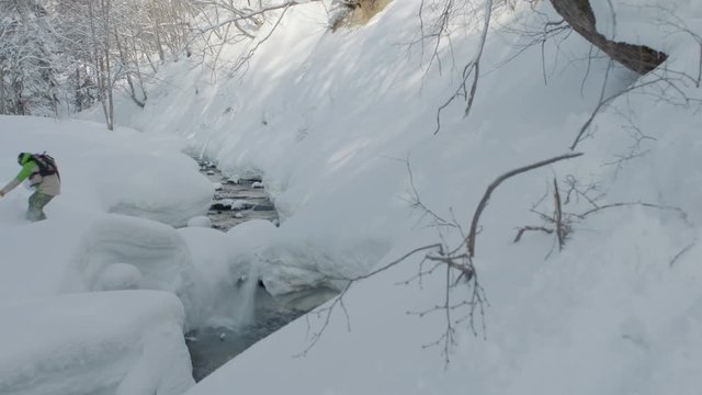 Snowboarding Jump Over River in Slow Motion