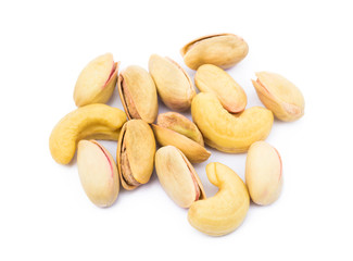 Pile of roasted pistachios and cashew isolated on white background