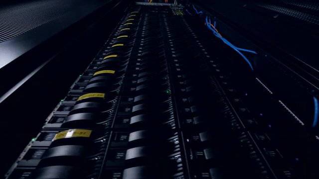 A low angle view on a data storage tower with many hard disks inside. 4K.
