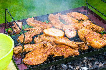 BBQ in the garden - selection of meat on flaming grill