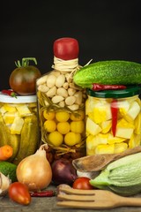 Zucchini slices in herbal vinegar with herbs and filled with canning container. Diet or health food concept.