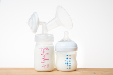 Breast pump milk bottle and bottle of milk.