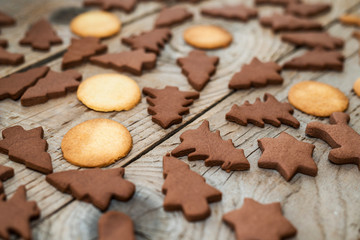 Christmas gingerbread cookies with different shapes over a vintage wooden table