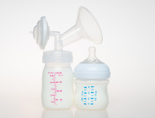 Breast pump milk bottle and bottle of milk.