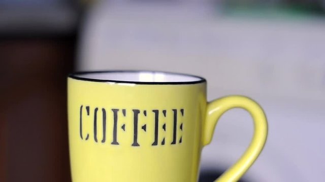 Pouring hot coffee into cup