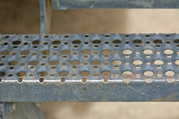 Close up of galvanised metal stair step with some signs of wear