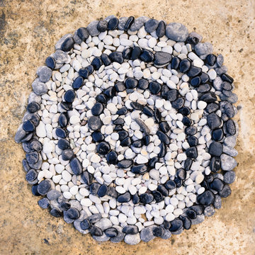 Spiral of black and white stones