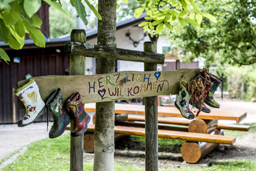 Party Label rubber boots sign wooden, forest tree house Herzlich Willkommen Means Welcome