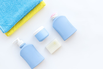 Bath accessories. Towels, soap, shampoo, lotion, cream on white background top view copyspace