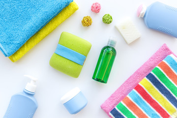 Obraz na płótnie Canvas Bath accessories. Towels, soap, shampoo, lotion, cream on white background top view