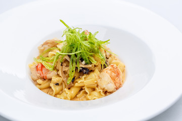 Ballerine pasta with shrimps in white plate