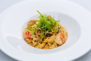 Ballerine pasta with shrimps in white plate