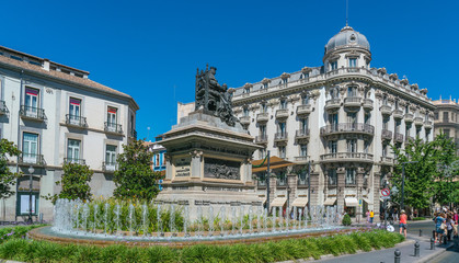 Fototapeta na wymiar Granada, Spain, juli 1, 2017: Statue and Fountain on Plaza de Carmen