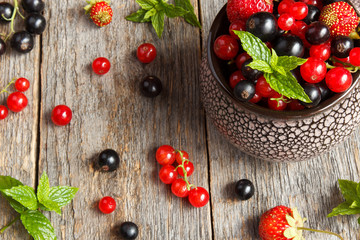 Fresh berries. Various summer berries in a bowl on rustic wooden table.