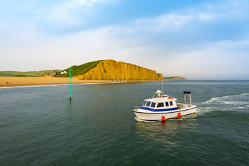 West Bay cliffs and fishing boat