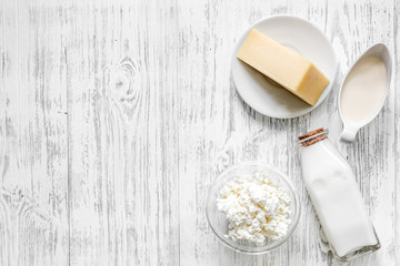 Farm dairy products. Milk, cottage, cheese, eggs on light wooden background top view copyspace