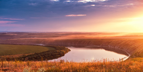 Summer river panorama. Panoramic view of the river bend in canyon at sunset.