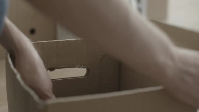 Man pulls a hammer out of the box. Man doing home renovations and pulls a hammer out of the box