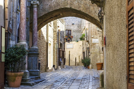 View of a street of erice with gothic arch