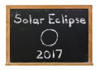 Solar Eclipse 2017 written in white chalk on a black chalkboard isolated on white