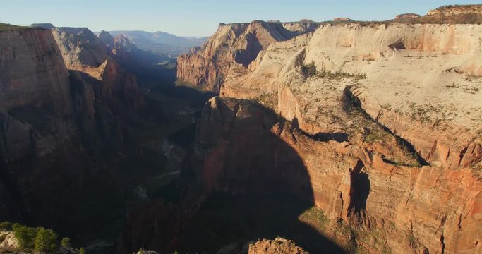 The sun rises over Zion National Park to reveal famed feature and hike, Angels Landing.