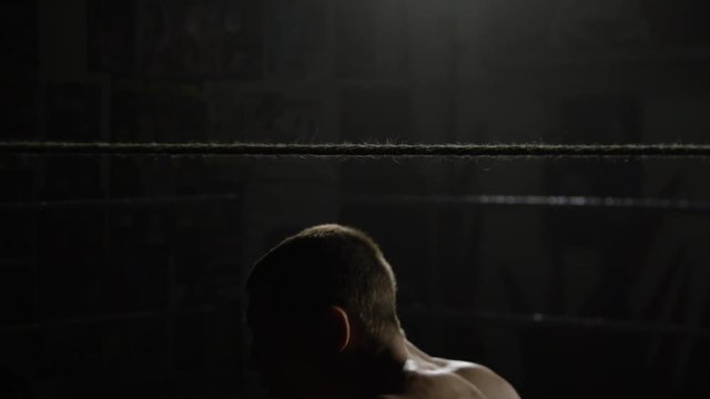 Boxer man doing exercises. Boxer doing exercises with a rope for slope, dives and punches