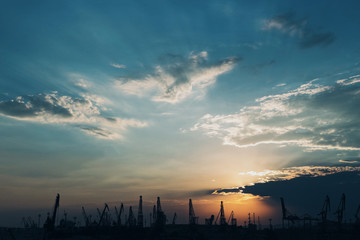 Obraz premium Sea port in shadow and beautiful sun flares. Sunset in Varna. Bulgaria