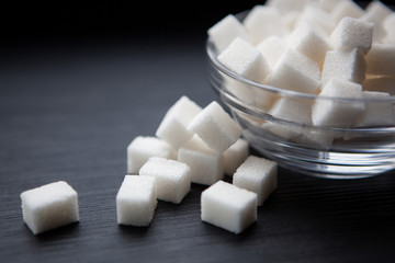 White sugar on black background