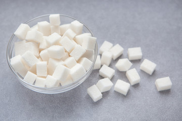 Fototapeta na wymiar White sugar cubes on gray background