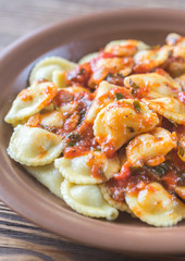 Portion of ravioli with marinara sauce