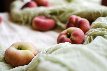 Flat Peaches on White Cloth