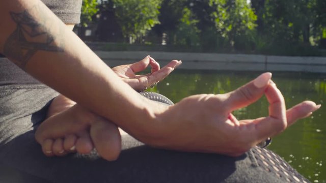 Hands of a woman clasped in mudras