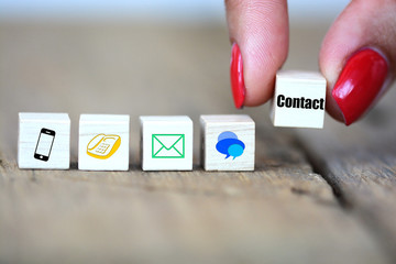Contact us concept with website icons on wooden cubes