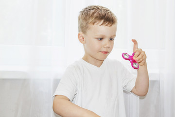 Young boy playing with  fidget spinner