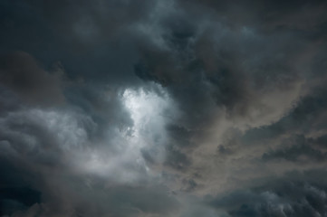 Naklejka na ściany i meble Stormy grey dramatic clouds in the sky before thunderstorm