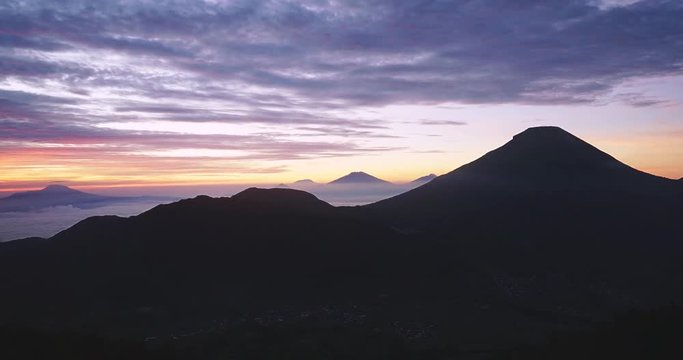 Beautiful time lapse of sunrise footage with mountain peak background in misty morning at Dieng Plateau, Wonosobo, Central Java, Indonesia. Shot in 4k resolution