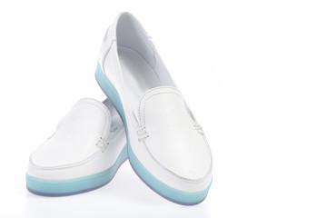 Pair of female leather sports shoes isolated on white background