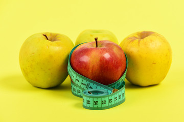 Apples and tape for measuring in greenish blue color