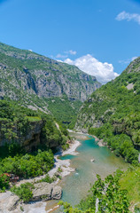 Fototapeta na wymiar The purest waters of the turquoise color of the river Moraca flowing among the canyons. Montenegro.