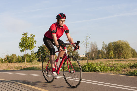 Sport and Cycling Concepts and Ideas. Male Caucasian Road Cyclist During Ride on Bike Outdoors. Completely Equipped in Professional Outfit.