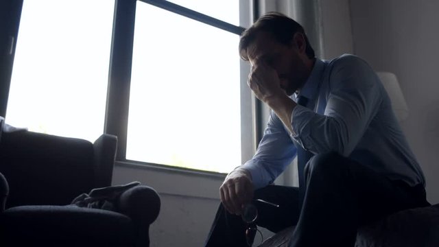 Depressed adult businessman feeling sad after being fired