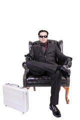 Killer sitting on chair, isolated on white background.