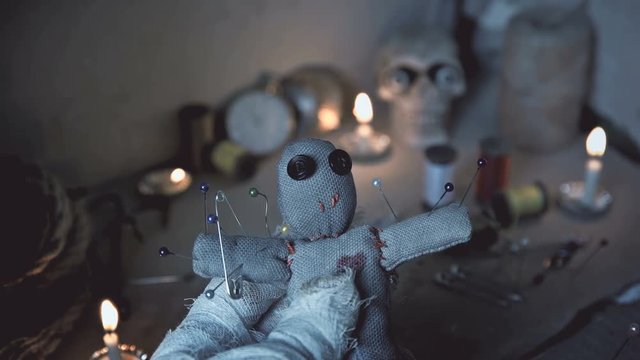 the mage conducts a ritual with a voodoo doll and sticks pins in it