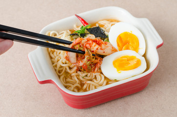 Instant noodles with boiled egg and kimchi in a bowl ready to eating,Korean food